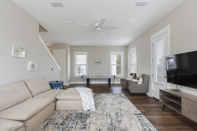 living room featuring dark hardwood / wood-style flooring and ceiling fan