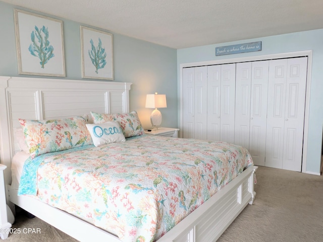 carpeted bedroom with a textured ceiling and a closet