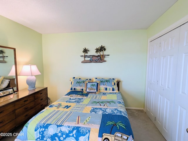 bedroom featuring a closet, baseboards, and carpet flooring