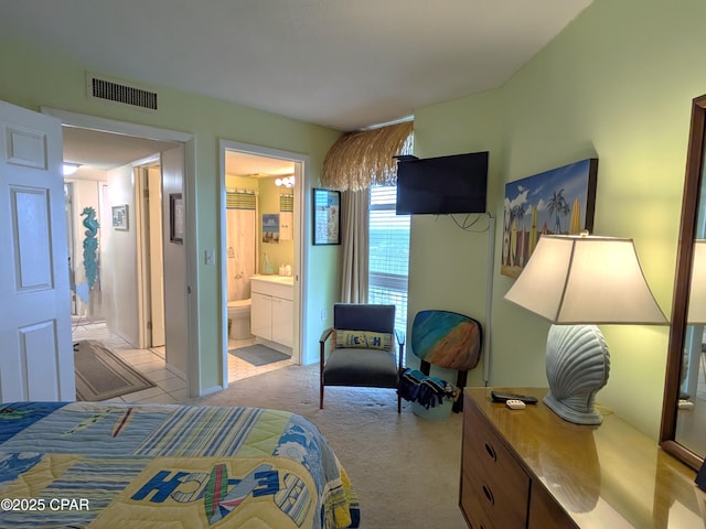 bedroom featuring light carpet, connected bathroom, and visible vents