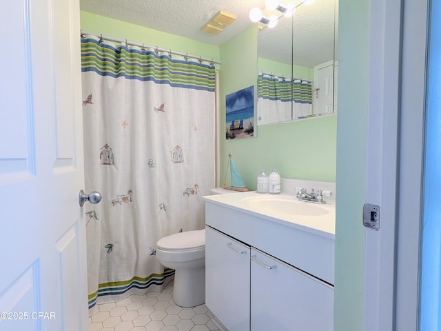 full bath with visible vents, toilet, a textured ceiling, vanity, and tile patterned floors