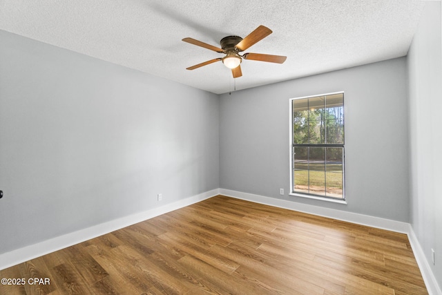 unfurnished room featuring ceiling fan, wood-type flooring, and a textured ceiling