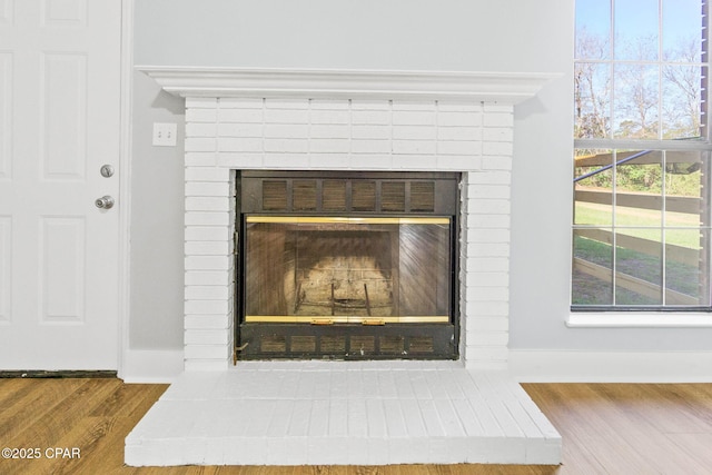 room details with hardwood / wood-style floors and a fireplace