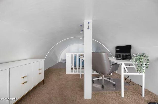 carpeted office with lofted ceiling