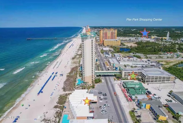 bird's eye view featuring a water view, a view of city, and a beach view