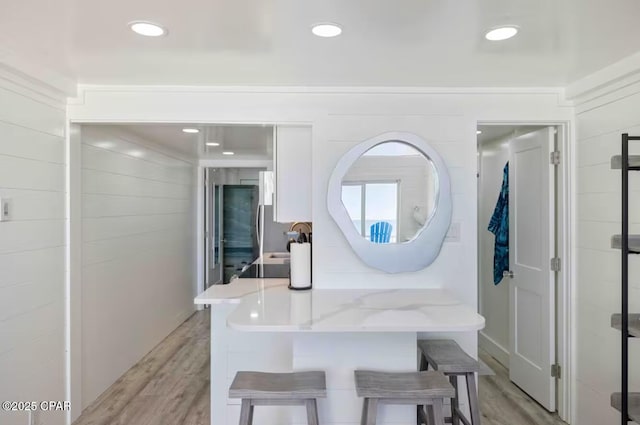 interior space with a sink, wood finished floors, and recessed lighting