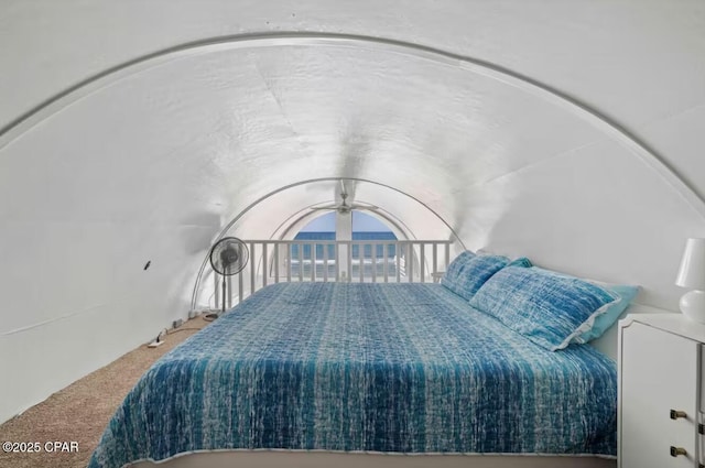 bedroom featuring carpet floors and vaulted ceiling