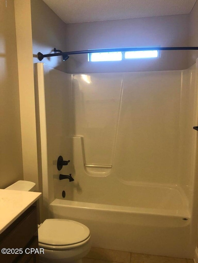 full bathroom with vanity, a textured ceiling, shower / bathtub combination, and toilet