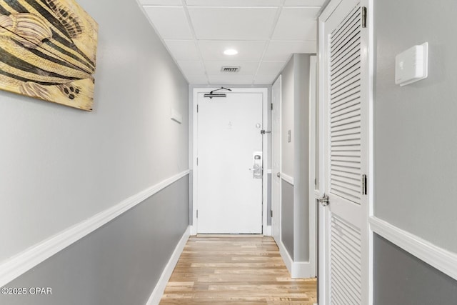 11757 Front Beach Rd Unit L104, Panama City Beach, FL 32407 - hallway with visible vents, baseboards, light wood-type flooring, and a drop ceiling