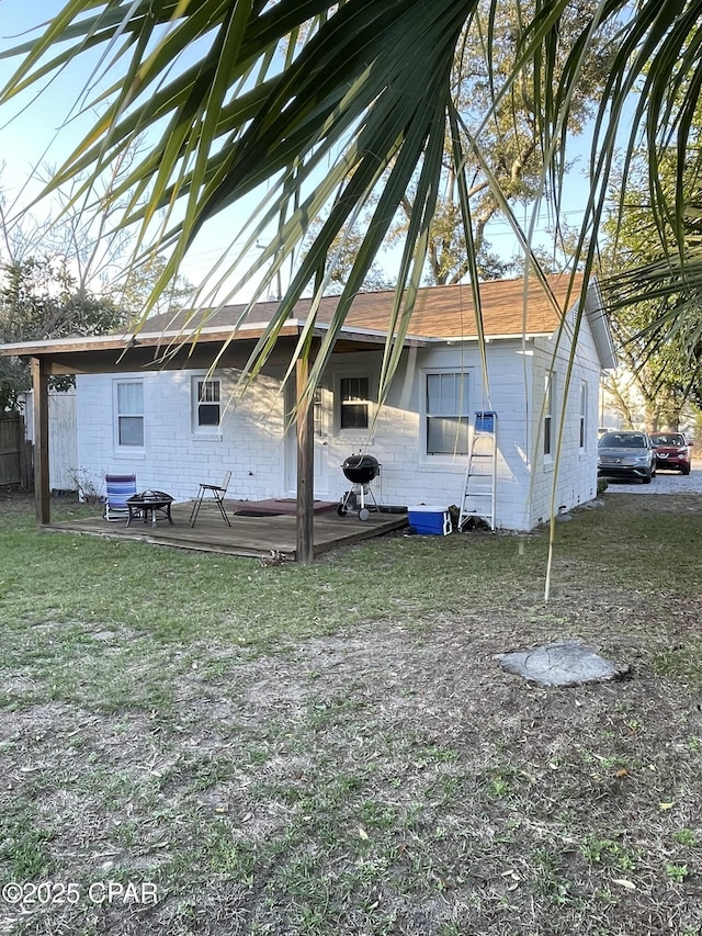 back of property featuring a lawn