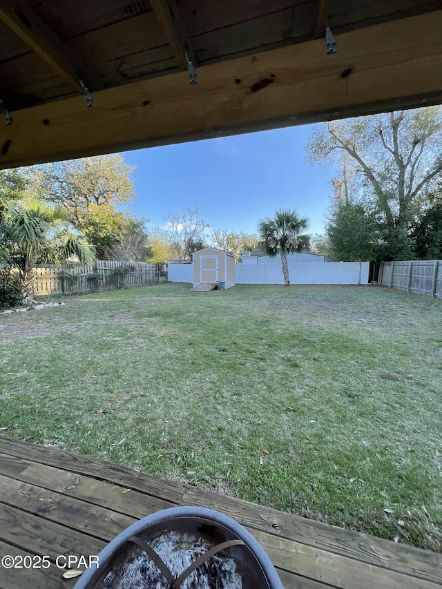 view of yard with a storage shed and a fire pit