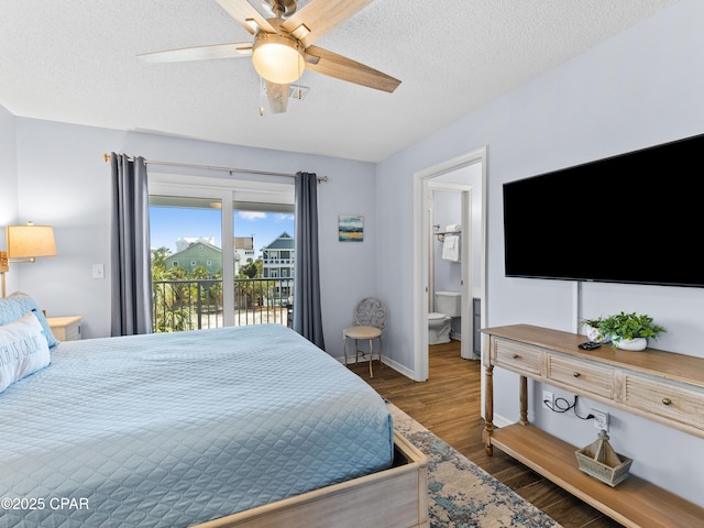 bedroom with a textured ceiling, connected bathroom, wood finished floors, baseboards, and access to exterior