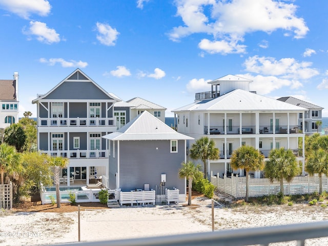 rear view of house with a balcony and a community pool