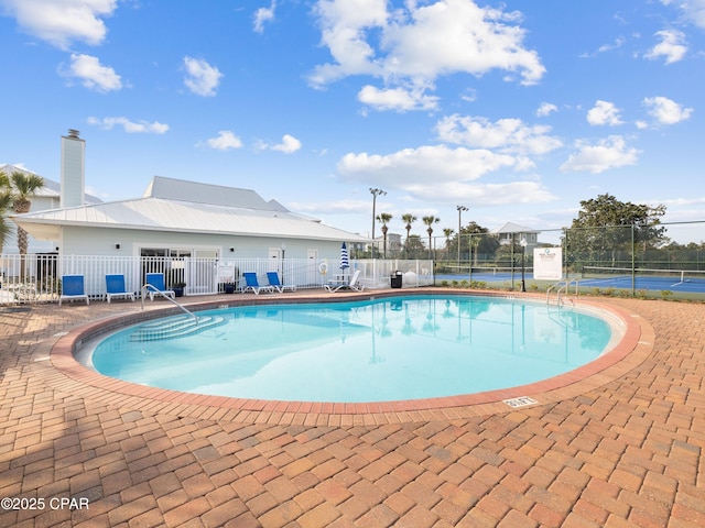 view of swimming pool featuring fence