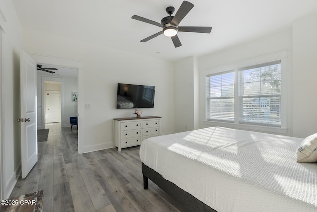 bedroom with ceiling fan and light hardwood / wood-style floors