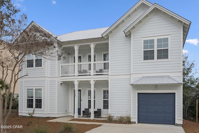 view of front of house featuring a garage, covered porch, and a balcony