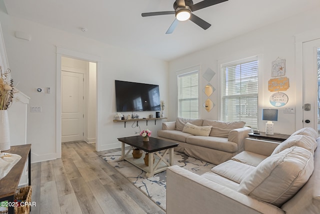 living room with light wood-type flooring and ceiling fan