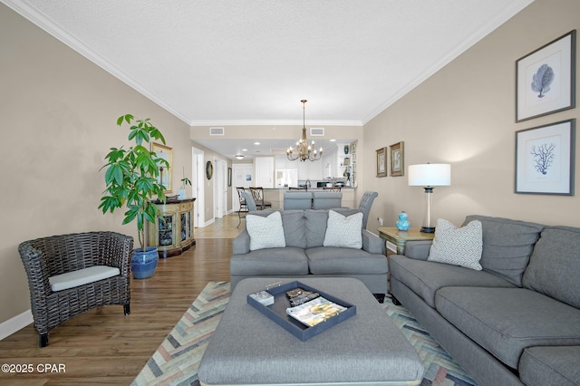 9450 S Thomas Dr Unit 802C, Panama City, FL 32408 - living area with a chandelier, wood finished floors, and ornamental molding