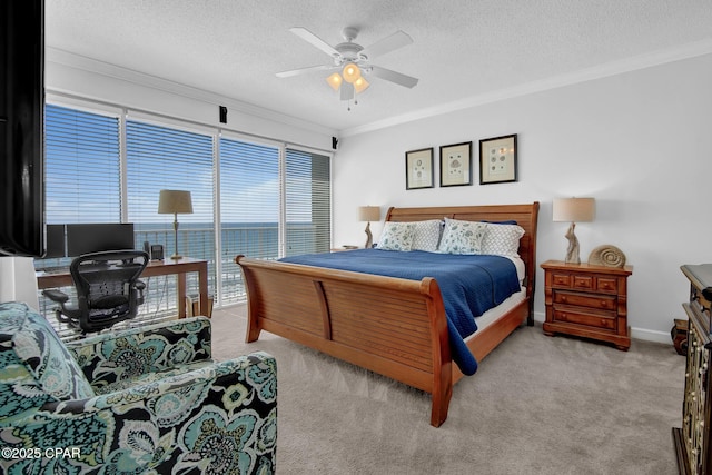 9450 S Thomas Dr Unit 802C, Panama City, FL 32408 - bedroom featuring crown molding, carpet flooring, a textured ceiling, ceiling fan, and an office area