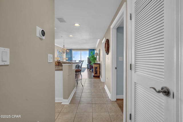 9450 S Thomas Dr Unit 802C, Panama City, FL 32408 - hallway with light tile patterned flooring, recessed lighting, and a chandelier