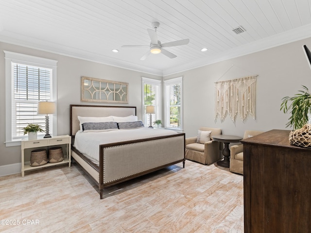 bedroom with ceiling fan, visible vents, ornamental molding, and light wood-type flooring