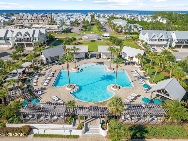 view of swimming pool with a residential view