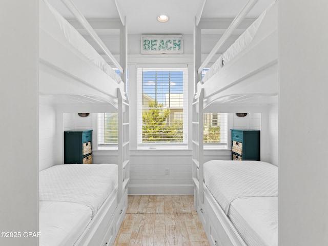 bedroom with recessed lighting, light wood finished floors, baseboards, and multiple windows