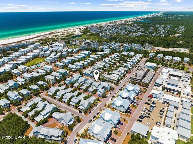 birds eye view of property with a water view, a beach view, and a residential view