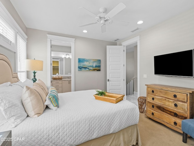 carpeted bedroom featuring visible vents, recessed lighting, a ceiling fan, and ensuite bath