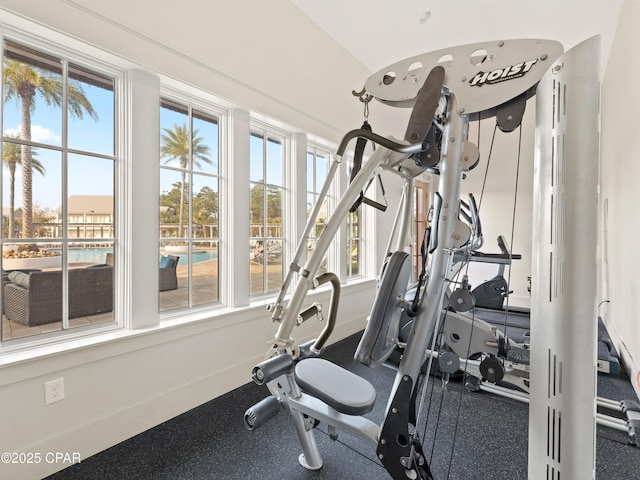 exercise room featuring baseboards and plenty of natural light