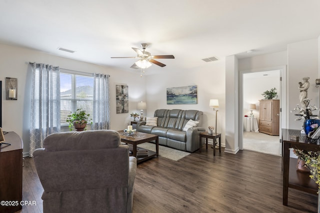 living room with dark wood-type flooring and ceiling fan