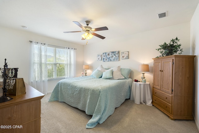 bedroom with light carpet and ceiling fan