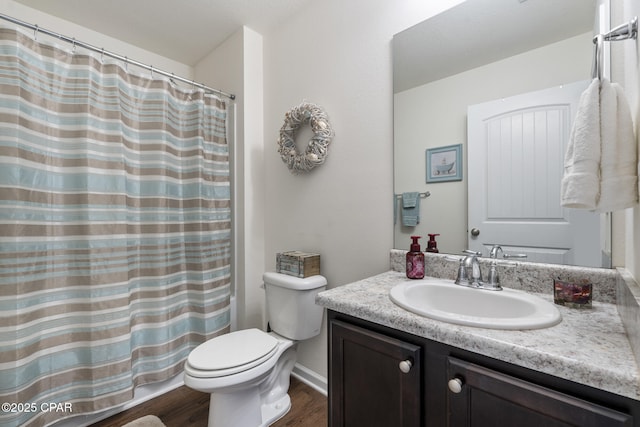 bathroom with vanity, toilet, and hardwood / wood-style floors