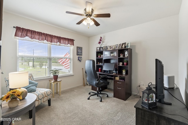 carpeted office space featuring ceiling fan