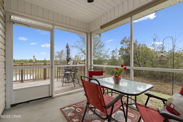 sunroom / solarium with a water view