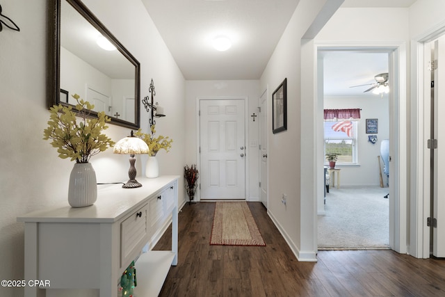 doorway to outside featuring ceiling fan and dark hardwood / wood-style flooring