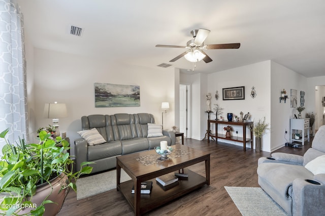 living room with dark wood-type flooring and ceiling fan