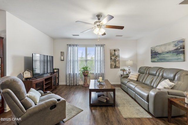 living room featuring dark wood-type flooring and ceiling fan