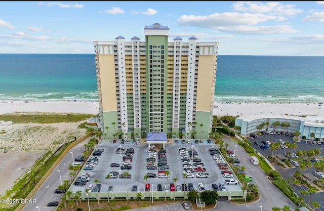 drone / aerial view featuring a beach view and a water view