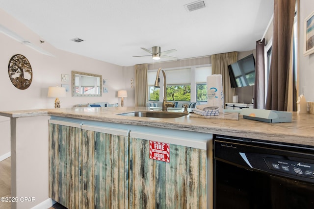 kitchen with beverage cooler, visible vents, ceiling fan, and a sink