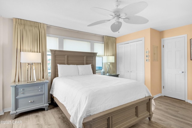 bedroom with a ceiling fan, a closet, baseboards, and wood finished floors