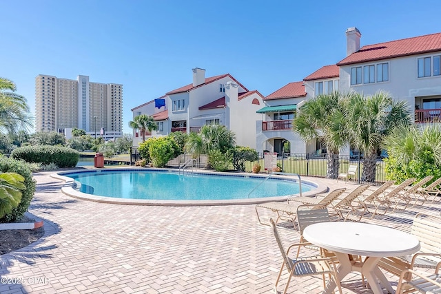 pool featuring a patio and fence