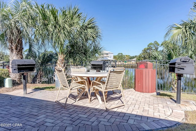 view of patio featuring outdoor dining space and fence