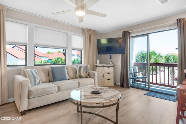 living area featuring ceiling fan, wood finished floors, and visible vents