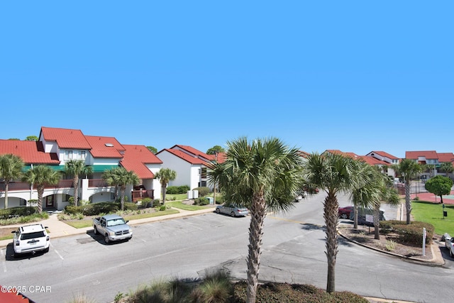 view of road featuring curbs, sidewalks, and a residential view