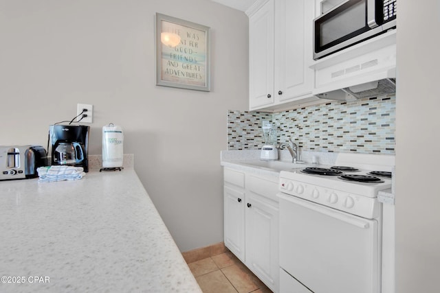 kitchen featuring white electric range oven, sink, white cabinetry, light tile patterned floors, and backsplash