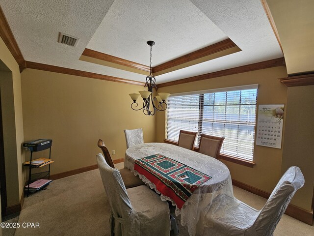 4408 Bylsma Cir, Panama City, FL 32404 - dining area featuring a chandelier, light colored carpet, a raised ceiling, a textured ceiling, and baseboards