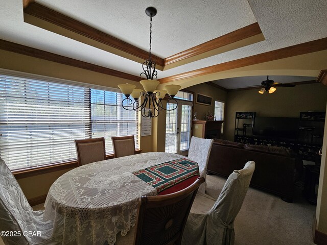4408 Bylsma Cir, Panama City, FL 32404 - carpeted dining area with a chandelier, healthy amount of natural light, a raised ceiling, a textured ceiling, and crown molding