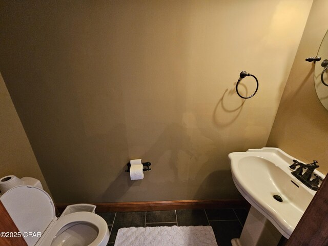 bathroom featuring sink, toilet, and tile patterned floors