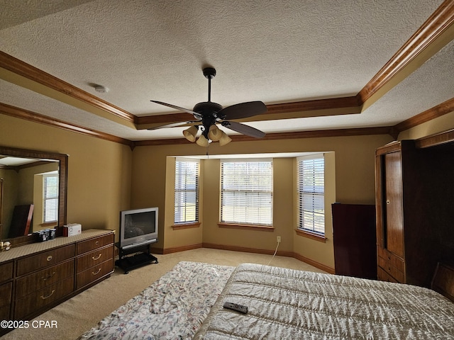 carpeted bedroom with a raised ceiling, a textured ceiling, and ornamental molding